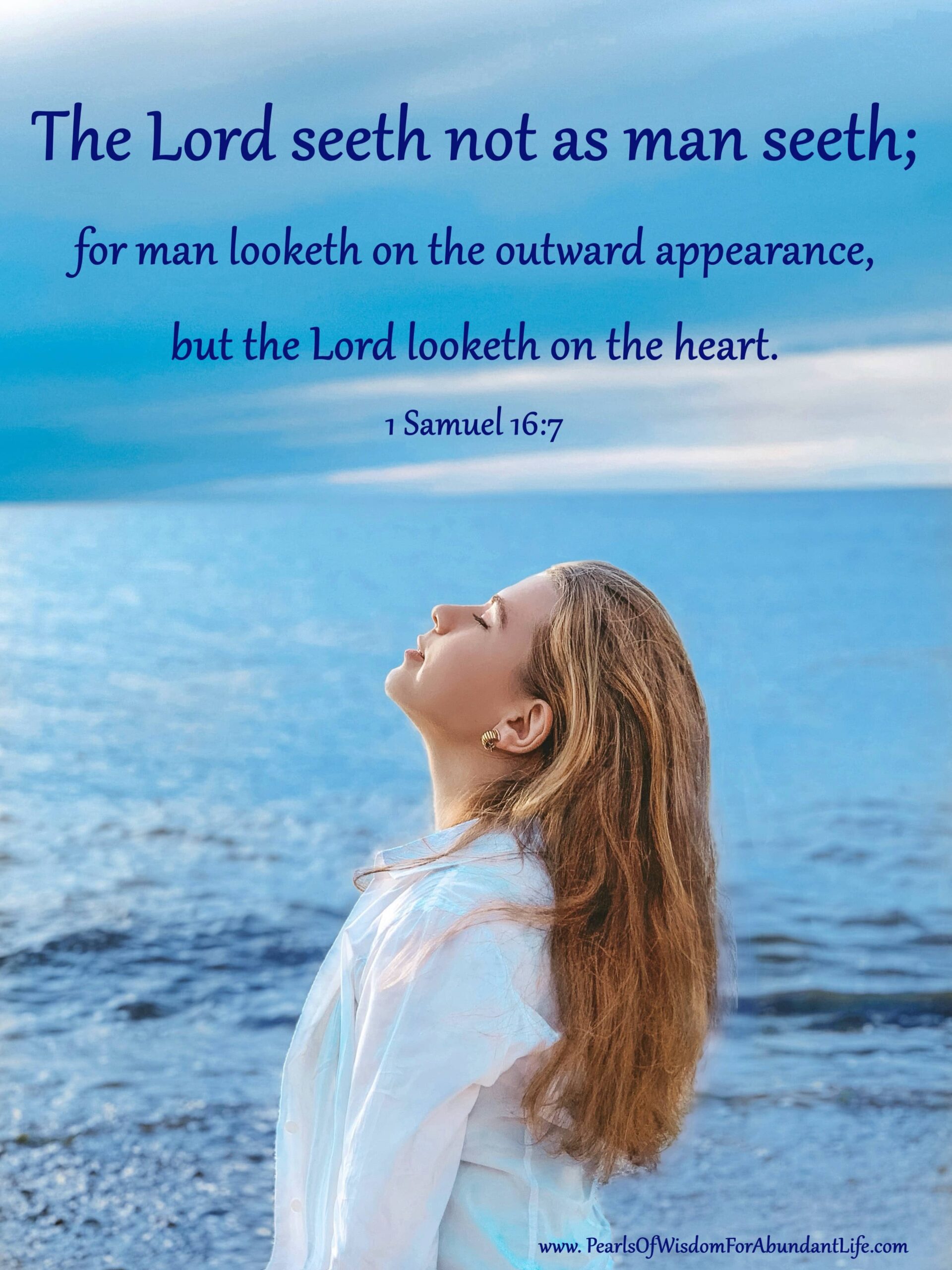 Woman looking upward with eyes closed, ocean behind her